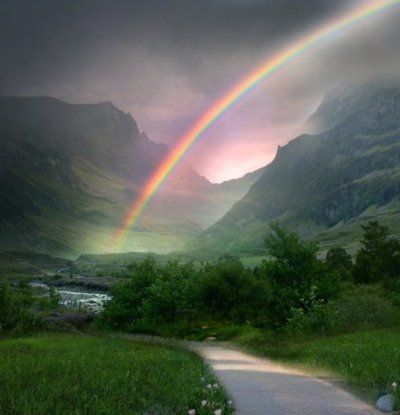 Pathway through mountains to a rainbow